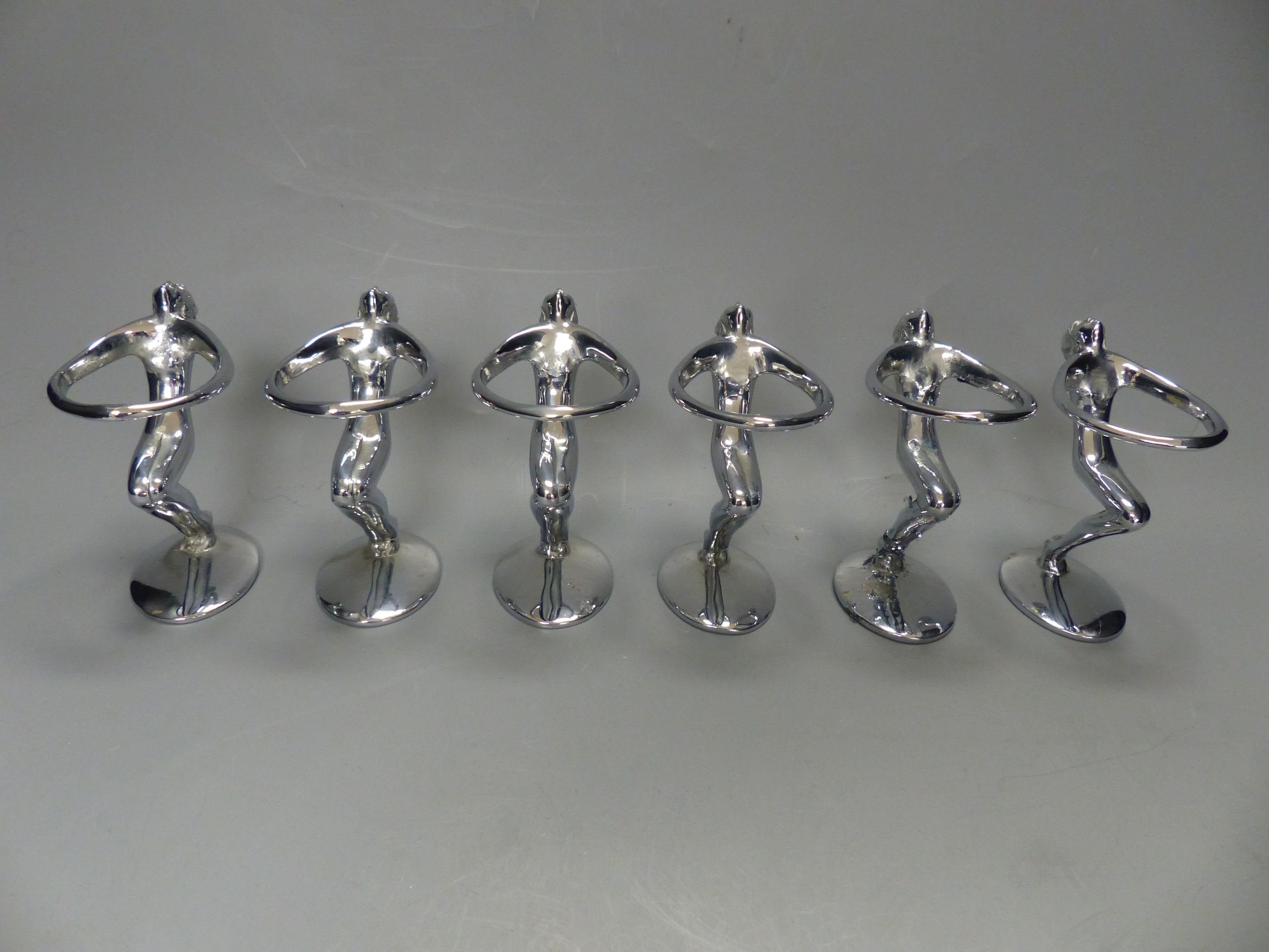 A post war chrome set of six figural egg holders, height 9cm